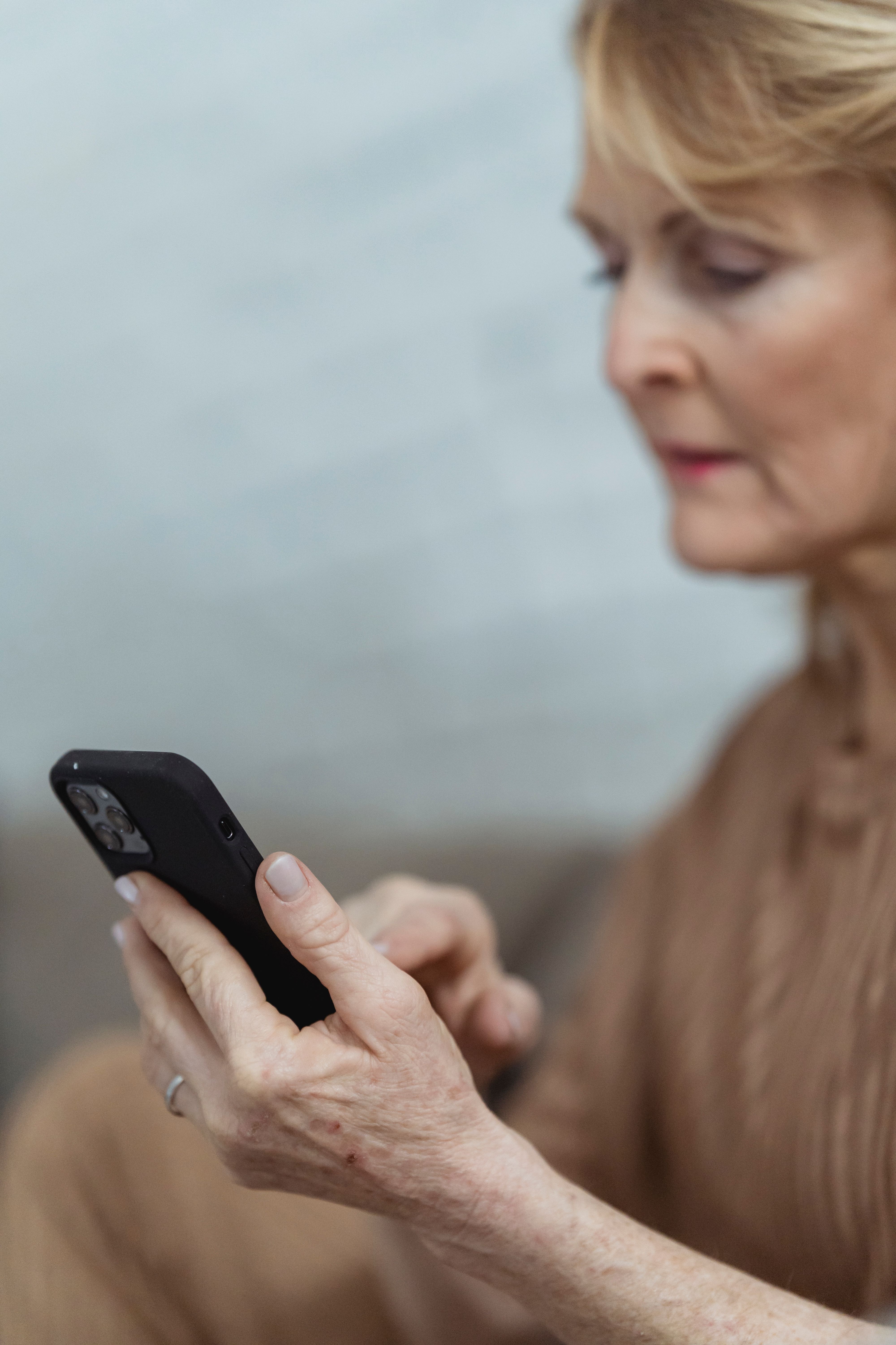 Older adult using a mobile phone to address a service question