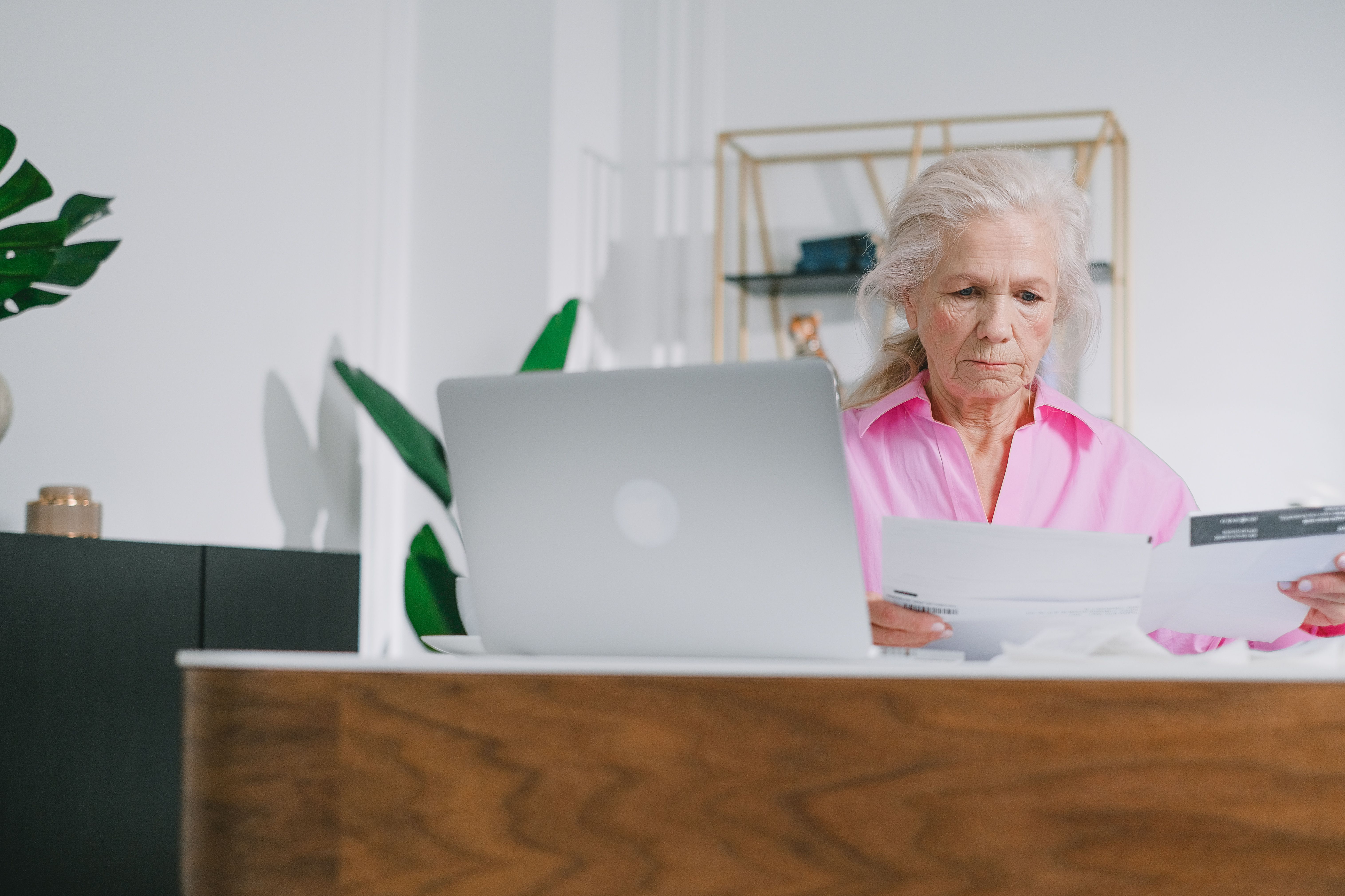 Older woman reviewing an important plan document at home